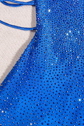 Close-up of a blue fabric with glittery embellishments on a beige background
