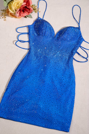Blue sequin dress on a light background with flowers in the corner