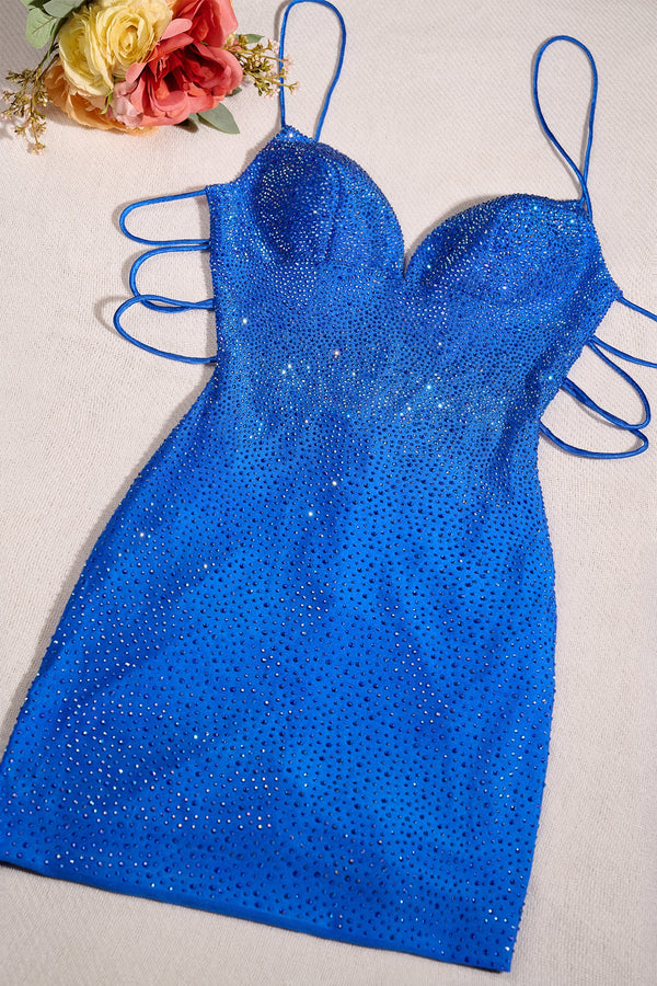 Blue sequin dress on a light background with flowers in the corner